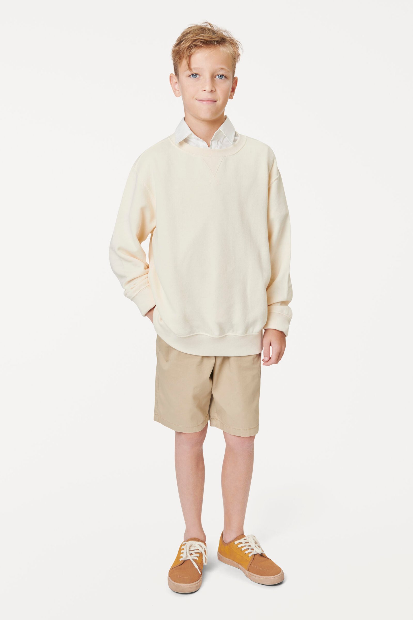 Boy wearing casual white sweatshirt in studio